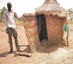 Gmangun Charles, of Kubone community in Ghana, shows off his household’s new latrine. (Photo by David Nunoo, SPRING/Ghana WASH Advisor)
